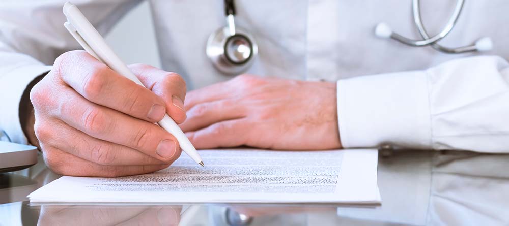 Close-up of physician reviewing and marking up a medical school personal statement