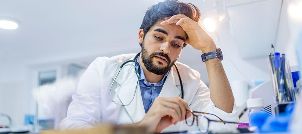  Male medical resident reviewing clinical notes