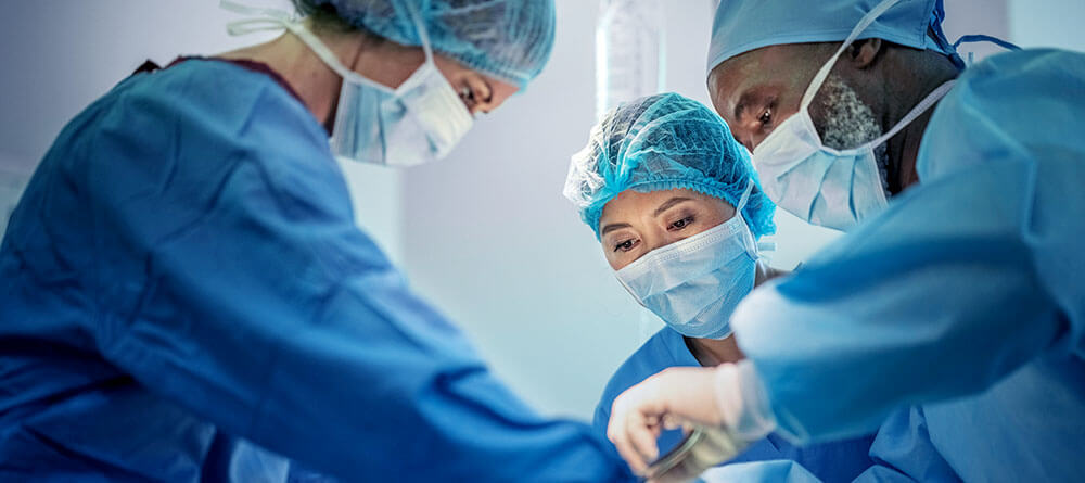 Group of physicians performing surgery