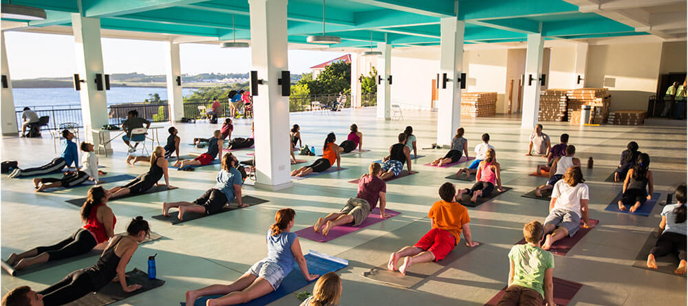 SGU students participating in a yoga class in an open campus space