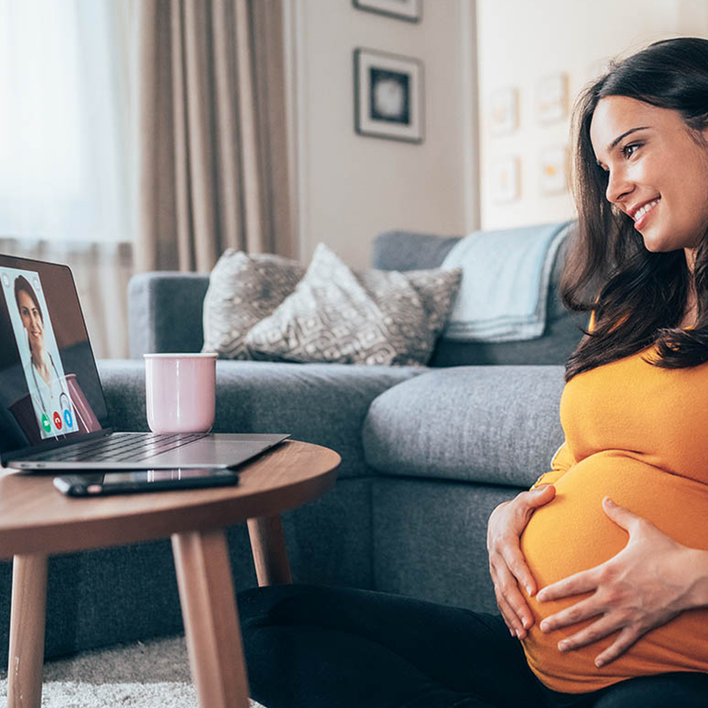 Pregnant woman on a video call with her female physician.
