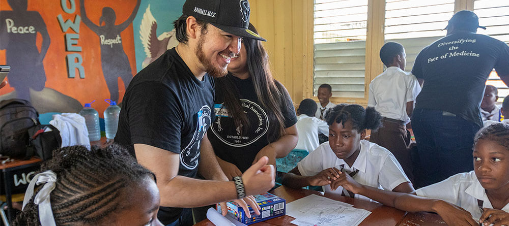 An SGU medical student volunteers with local Grenada youth