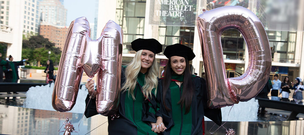 Recent SGU medical school graduates pose with balloons