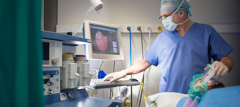 An anesthesiologist monitors a patient during surgery.