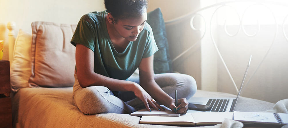 Female medical student sitting on bed studying