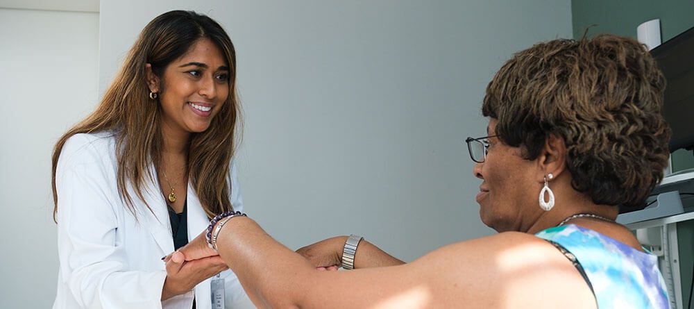 An SGU resident student examines a patient during an exam
