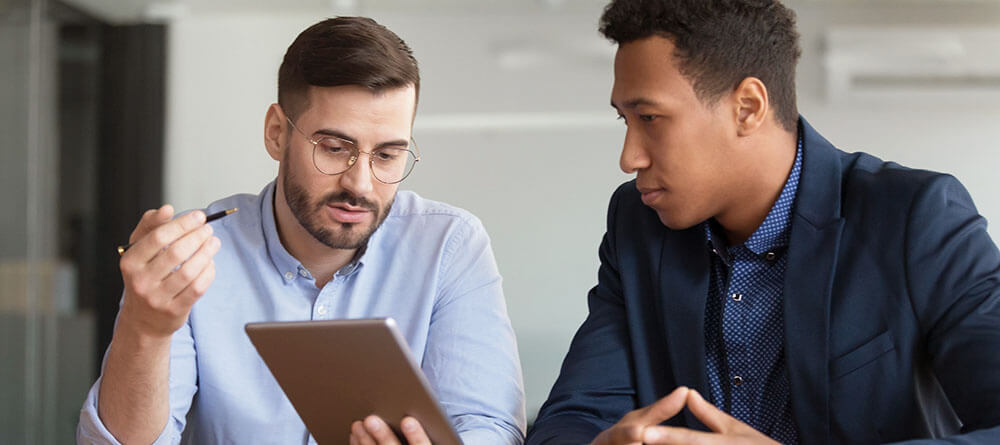 A college student discusses their personal statement letter with a mentor
