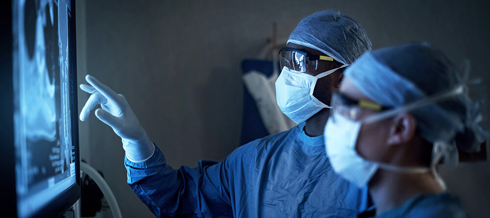 Orthopedic surgeon reviewing x-ray prior to surgery