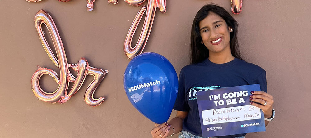 An SGU medical student smiles for their Match Day photo.