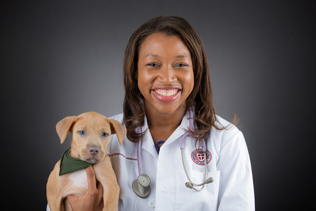 SGU veterinary student posing with puppy