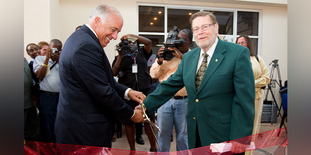 Charles Modica and Patrick Adams cut a ribbon at the dedication of the new Patrick F. Adams Hall in 2011. |Chancellor Charles Modica + Patrick F. Adams at Hall dedication ceremony